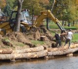 Marvin Creek stream bank gets stabilized with logs to help prevent further damage from erosion and help protect the wildlife habitat.